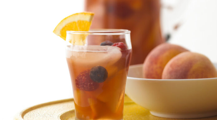 This Peachy Iced Tea Sangria has a fruity twist on iced tea that’s packed with delicious summer berries and peaches.